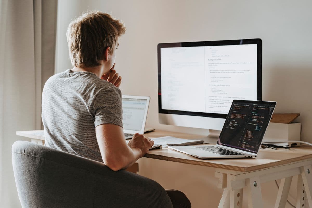 A developer working across multiple screens during a build