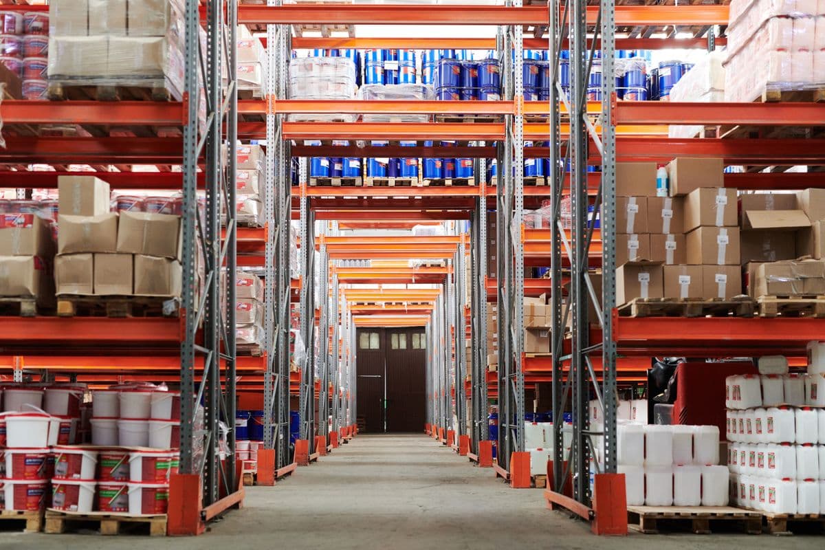 A wide view of a stocked warehouse with shelved inventory