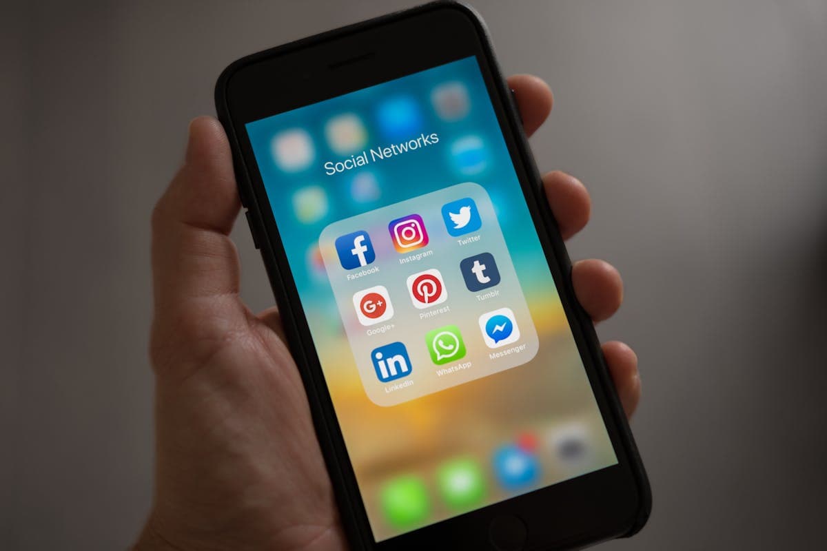 Person checking phone notifications, the channel SMS lives in. Photo: Pexels, free license.
